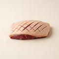 Raw duck magret with scored fat