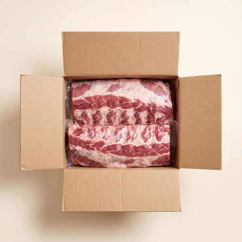 Full box — vacuum-sealed portions of baby back ribs nat cooked